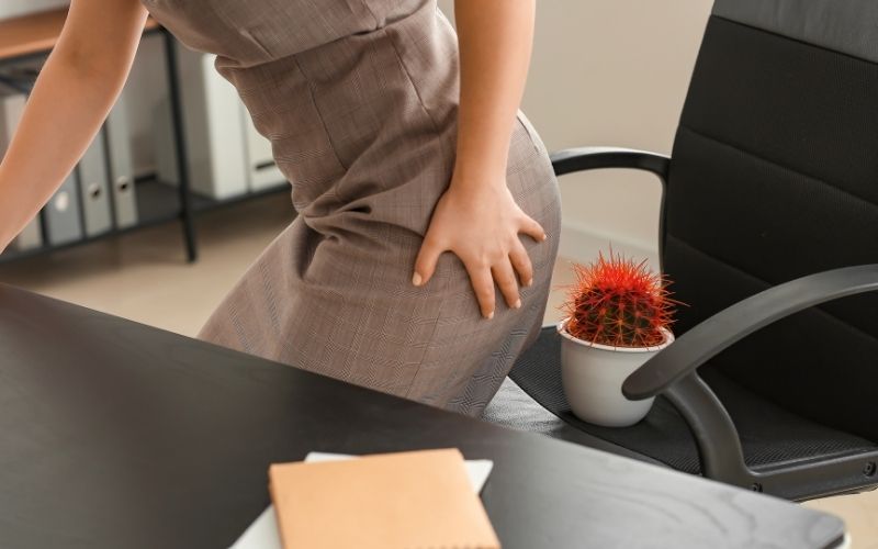 Woman suffer from Hemorrhoids in office