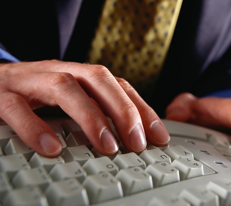 A Man using Ergonomic Keyboard