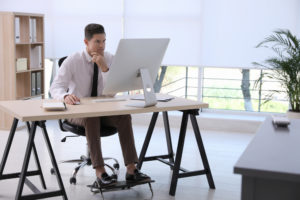 A man using footrest in his office