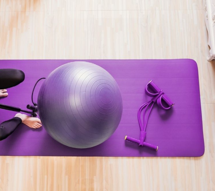 A woman inflates her exercise ball