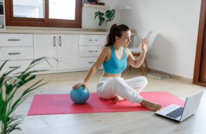 A woman using a small exercise ball