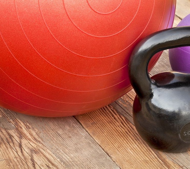 Exercise balls next to a weight