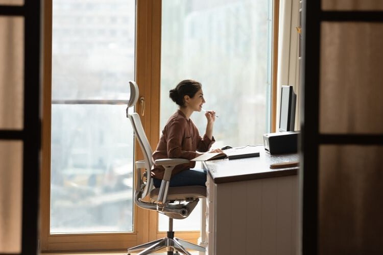 a young girl is sitting on an office chair in her office