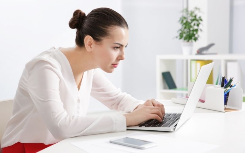 Woman in slouching posture at work