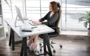 Woman sitting in good posture using footrest