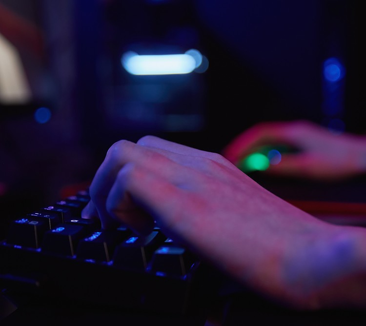 A person using keyboard in the dark