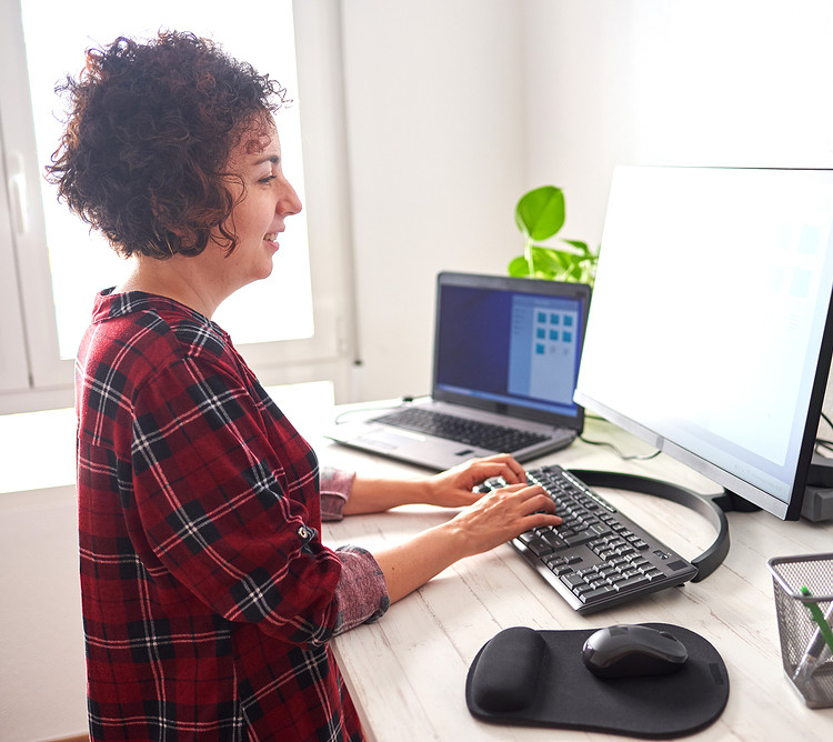 A woman using ergonomic keyboard in work