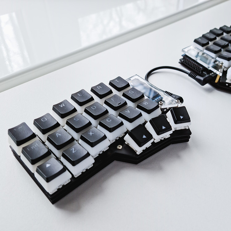An Ergonomic Keyboard on a white table