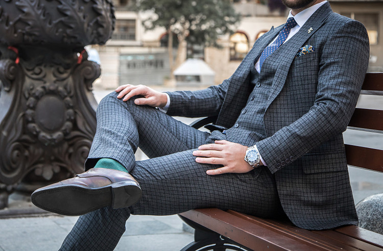 A man sitting cross-legged in public