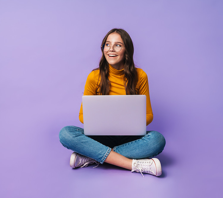 A woman sitting Cross-Legged with purple background