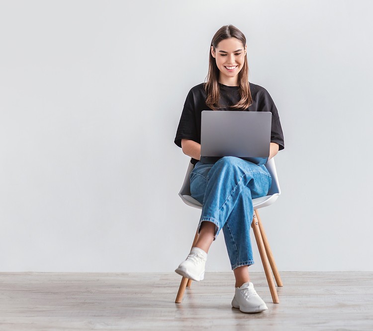 A women sitting comfortably on an armless chair