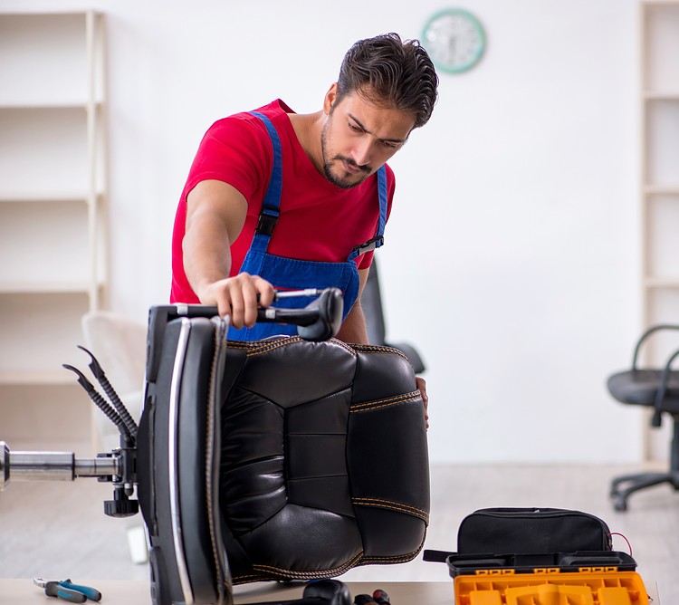 A man repairing an office chair