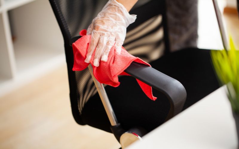 using the cloth to clean a mesh office chair