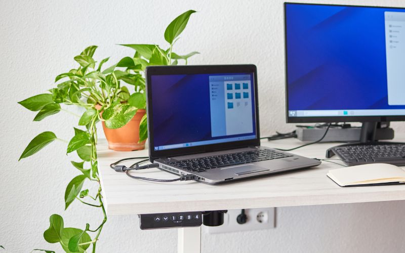 adjustable standing desk with the button panel on the left-corner