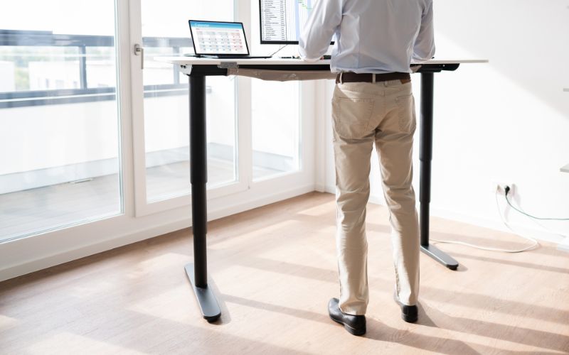 man is using an adjustable height standing desk